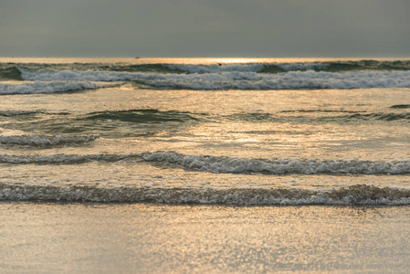 Scenery of soft waves on the beach at late evening 