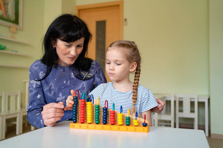 a teacher with girl learning to add and subtract 