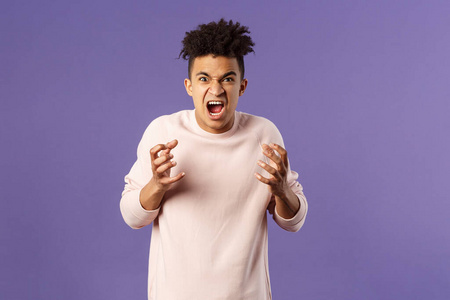 可恨的,愤怒的年轻西班牙裔男子的画像,发脾气,想勒死或攻击某人,诅咒