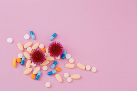  Red virus and a diverse pill on a pink background, the risk of 