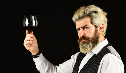 侍者品尝昂贵的饮料.优雅的侍者喝酒.在酒窖工作.酒吧或酒庄照片