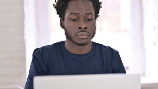 非洲年轻人在笔记本电脑上工作的特写镜头