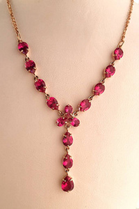  Gold ruby necklace on a jewelry stand. luxury jewelry.