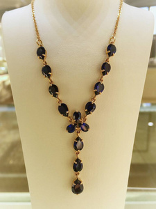  Gold sapphire necklace on a jewelry stand. luxury jewelry.