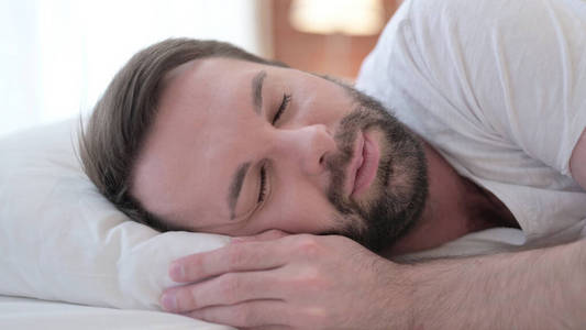 Close up of Peaceful Beard Young Man Sleeping in Bed 