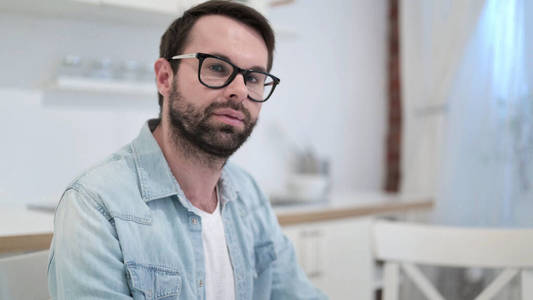 Serious Beard Young Man looking at Camera 