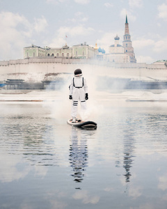 An astronaut in a spacesuit stands on a sup board and floats on 