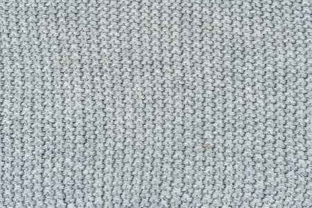 灰色针织柔软温暖舒适的纹理背景。格纹毛衣。