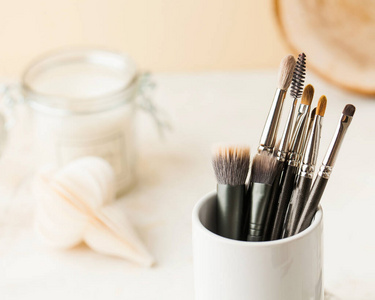  Professional makeup brushes in a white stand with place for tex