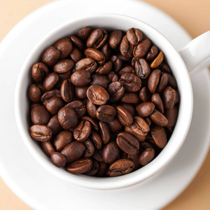  Closeup of a white mug with coffee beans arabica. 