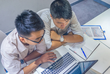 Businessman using laptop and having business discussion with his