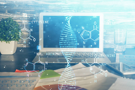 桌面电脑背景和DNA绘图。双重曝光。科学概念。