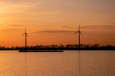Moerdijk Netherlands, sunset winth windmills by the lake Vokerak
