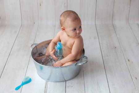 Little baby takes a bath. 