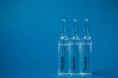 Medicine in an ampoule on a blue background. 