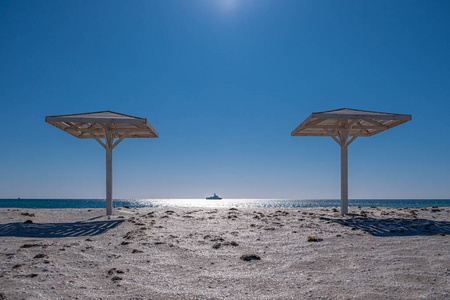 Beach. Umbrella from the sun. Sand. Canopy. Sea. Blue sky. No pe