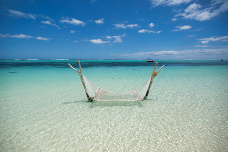 Empty overwater hammock in the middle of tropical lagoon.