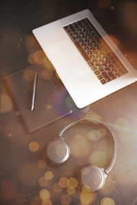 Dark modern workplace with a graphic tablet, laptop, wireless he