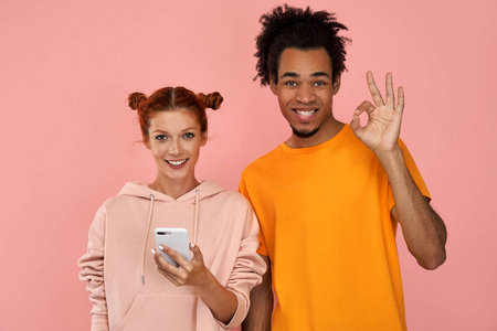 心满意足,皮肤黝黑的快乐男人和姜黄色的女人用现代科技打发闲暇时光