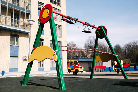  An empty playground for children in the yard. Fenced territory