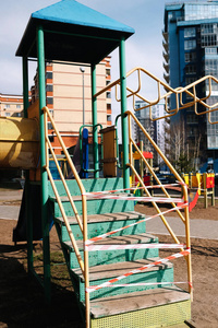  An empty playground for children in the yard. Fenced territory