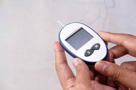 hand holding diabetic measurement kit isolated on white 