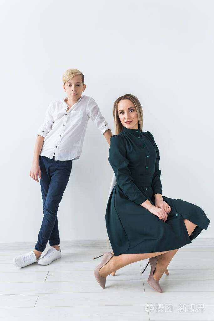青少年和单亲母亲年轻的母亲和儿子在一起在白色的背景