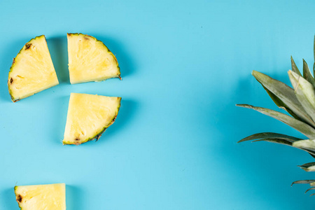 Fresh pineapple cubes isolated on blue background 