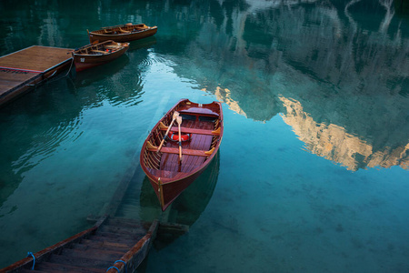 Emerald Mountain Lake Braies. boat station. Wooden pier. Morning