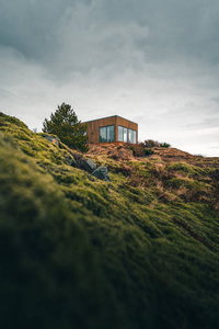 A tiny house on a grassy hill perfect for isolated vacation or j