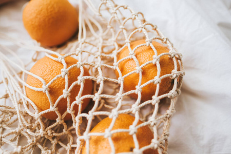  Mesh eco bag with fresh oranges.