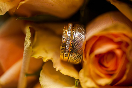 Wedding rings on pink roses background 