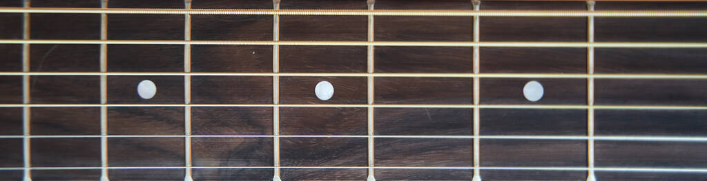 Guitar fretboard. Banner. Closeup. Vulture of an acoustic guita