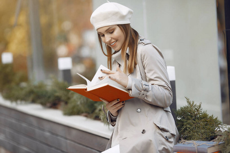 Elegant woman in a brown coat in a spring city