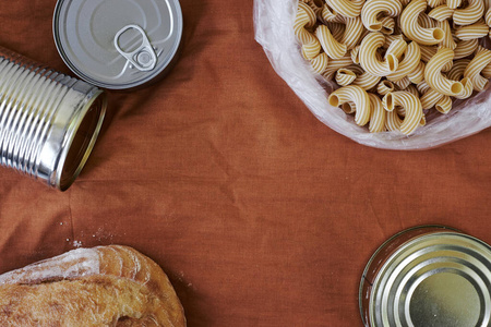 A close up of food canned, bread, pasta in the background for si