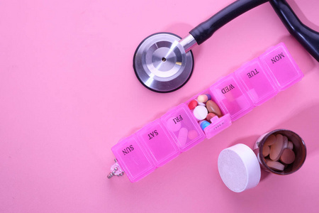 stethoscope, pills, thermometer on color background, top view 