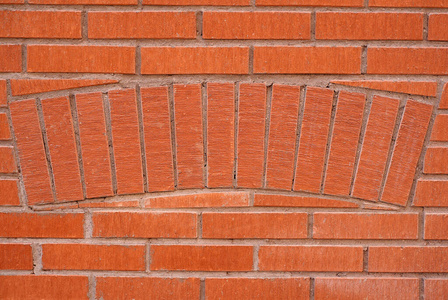 Red brick wall, masonry in a semicircle 