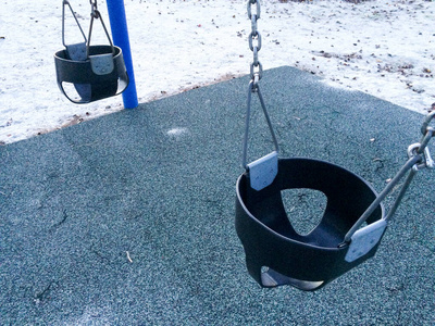 Empty swing at playground for baby and toddler