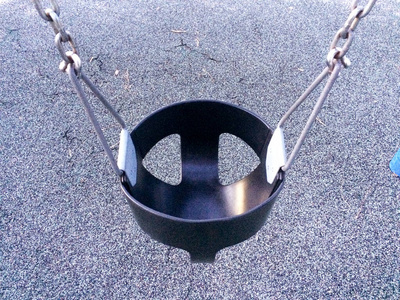 Empty swing at playground for baby and toddler