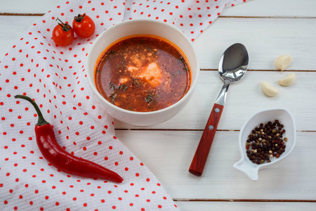 Delicious tomato soup with sour cream for lunch on the white woo