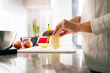 Woman prepares the ingredients to make a sponge cake 