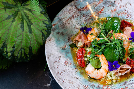 Prawn salad view from above in a deep plate against the backgrou