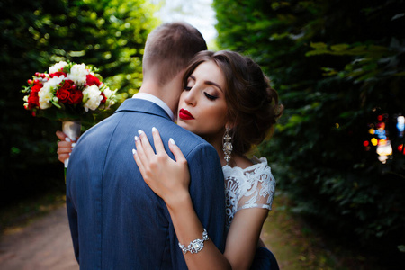 Elegant bride and groom posing together outdoors on a wedding da