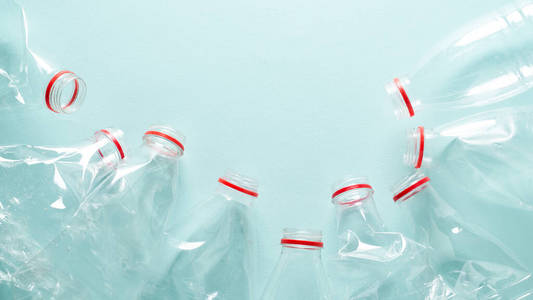 Empty crumpled plastic bottles at blue background