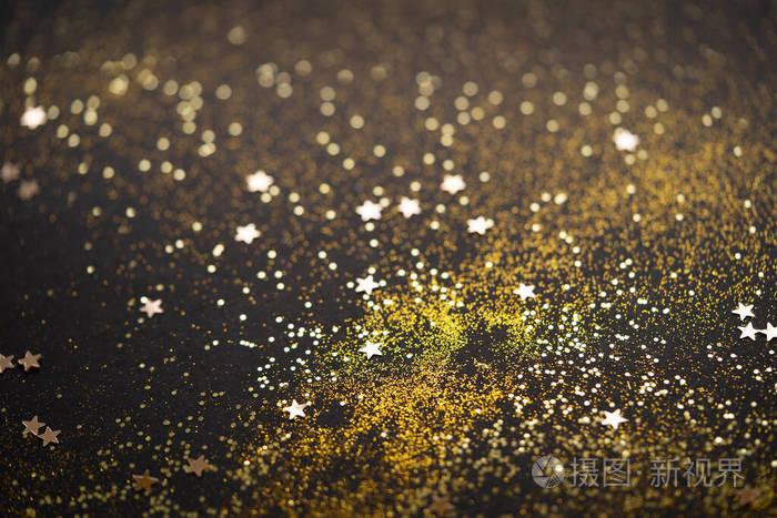 美丽的圣诞灯光背景抽象的闪光点和分散的金色火花黑色