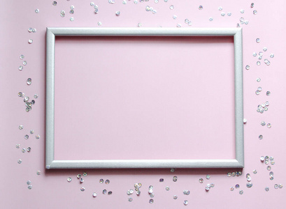 Empty frame silver with the confetti and space for text on pink 