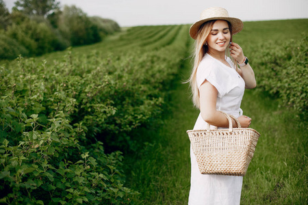 Elegant and stylish girl in a summer field