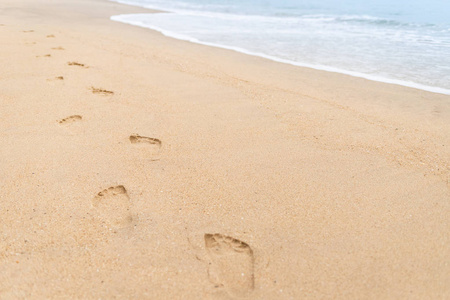 沙滩和海浪上行走的脚印图片