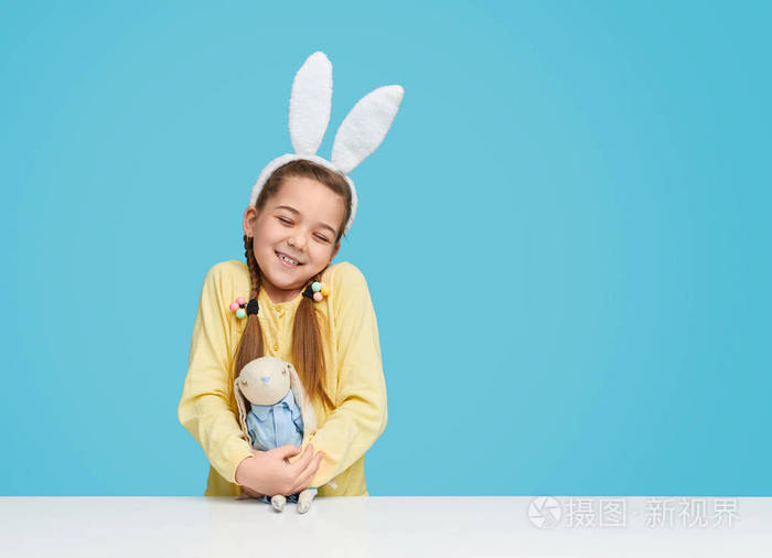 Charming happy girl holding Easter toy 