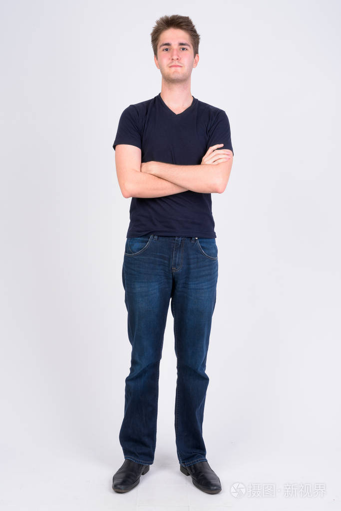 年轻帅哥双臂交叉的全身照
